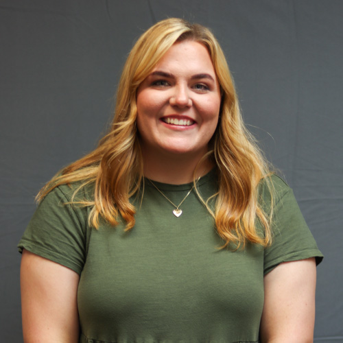 Smiling woman with blonde hair in a green t-shirt